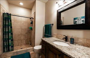 Full bath with a shower stall and vanity
