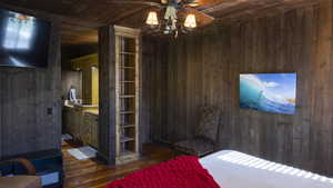 Unfurnished bedroom with dark wood-style floors, wooden ceiling, and wood walls