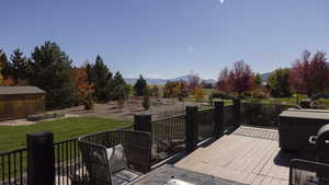 Wooden terrace with a mountain view and an outbuilding