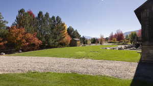 View of community with a storage unit, a lawn, and a mountain view