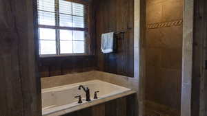 Full bath featuring a garden tub and a walk in shower
