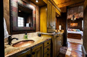 Full bathroom featuring vanity, ceiling fan, dark wood finished floors, and wooden ceiling