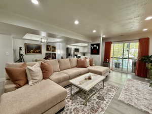Living room with recessed lighting and light wood finished floors
