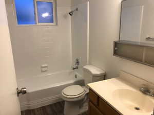 Garden level full bath with a vanity and either laminate or vinyl flooring