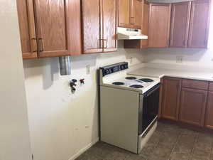 Upstairs unit kitchen with vinyl flooring