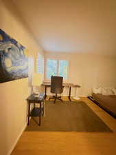 Office space featuring light wood-type flooring and baseboards