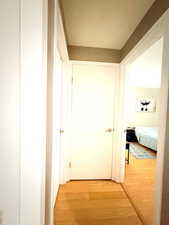 Hallway with light wood-style flooring