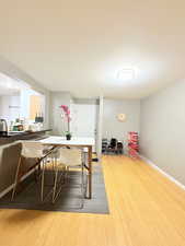 Dining room with light wood-style flooring and a textured ceiling