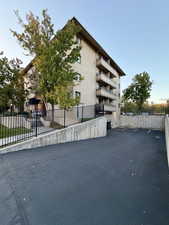 View of apartment building / complex featuring uncovered parking
