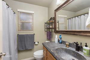 Full bathroom featuring curtained shower and vanity