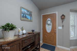 Entryway with light wood-style flooring and baseboards