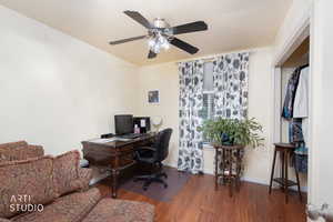 Office area with wood finished floors and a ceiling fan
