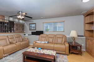 Living room with wood finished floors and a ceiling fan