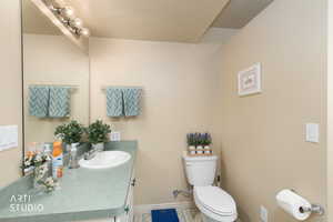 Half bath with vanity and tile patterned floors