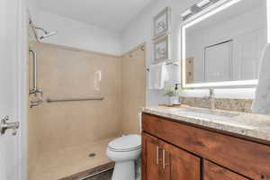 Full bathroom featuring vanity, a shower, and tile patterned floors