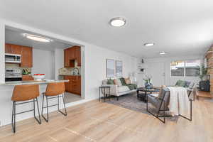Living area with light wood-style floors and a textured ceiling