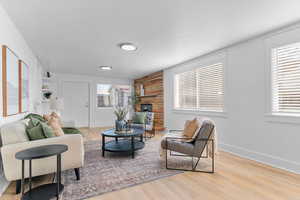 Living area with light wood-type flooring and a textured ceiling