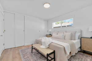 Bedroom featuring light wood-type flooring and two closets