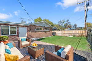 Fenced backyard featuring a patio and outdoor lounge area