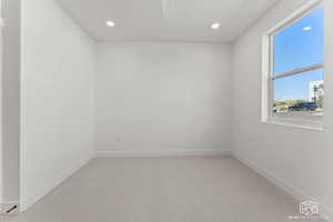 Unfurnished room with light carpet and recessed lighting