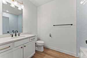Bathroom featuring light wood finished floors, vanity, and shower / tub combination