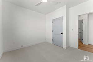 Unfurnished bedroom featuring carpet floors and ceiling fan