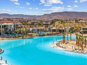 Community pool with a mountain view, a residential view, and a patio area