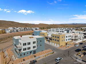 View of property with a mountain view and a residential view