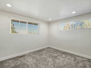 Unfurnished room with light carpet and recessed lighting