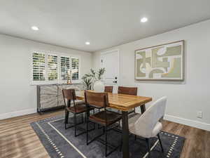 Dining room with recessed lighting and dark wood-type flooring