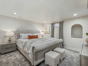 Bedroom featuring a textured ceiling, carpet floors, and recessed lighting