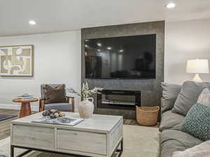 Living area featuring recessed lighting, wood finished floors, and a textured ceiling