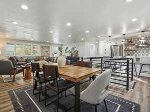 Dining space with light wood finished floors, recessed lighting, and a textured ceiling