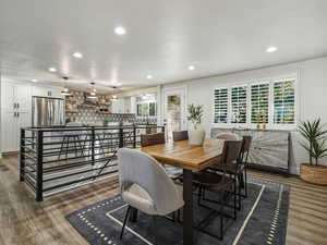 Dining space with recessed lighting, light wood-style floors, and a textured ceiling