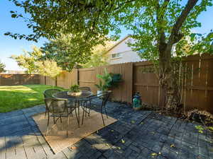 Fenced backyard featuring a patio area and outdoor dining area