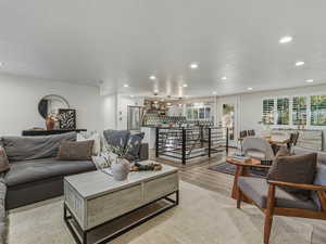 Living area featuring light wood-style floors, recessed lighting, and a textured ceiling