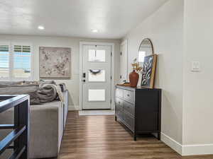 Foyer entrance featuring dark wood finished floors and a textured ceiling