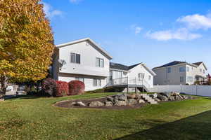 Rear view of house with stairway and a wooden deck