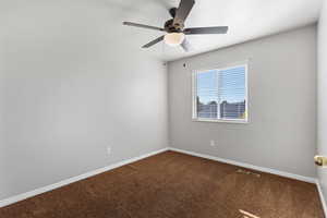 Empty room with carpet floors and a ceiling fan