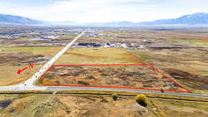 Overview of rural landscape featuring property boundaries highlighted and a mountain backdrop