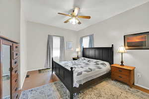 Bedroom with a ceiling fan and light wood finished floors