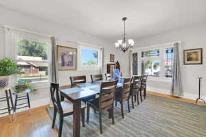 Dining space with light wood-type flooring and a chandelier
