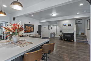 Dining room with recessed lighting, stairway, dark wood-style flooring, and a textured ceiling