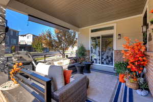 Porch featuring a grill