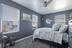 Bedroom featuring carpet floors, a textured ceiling, and a ceiling fan