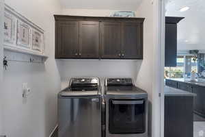 Laundry room with cabinet space, separate washer and dryer, and recessed lighting