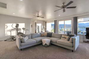 Living area with carpet, an office area, ceiling fan, a mountain view, and recessed lighting