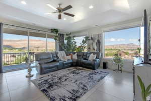 Living room featuring ceiling fan, recessed lighting, and light tile patterned flooring