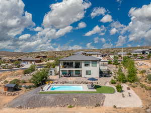 Back of property with a patio, an outdoor pool, stucco siding, and a fenced backyard