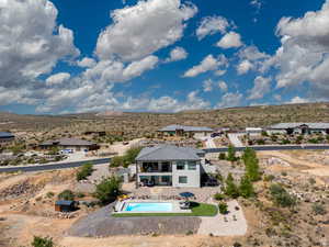 View from above of property with a pool and mountains
